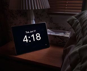 iPad Disappearing Beside Clock on a night table
